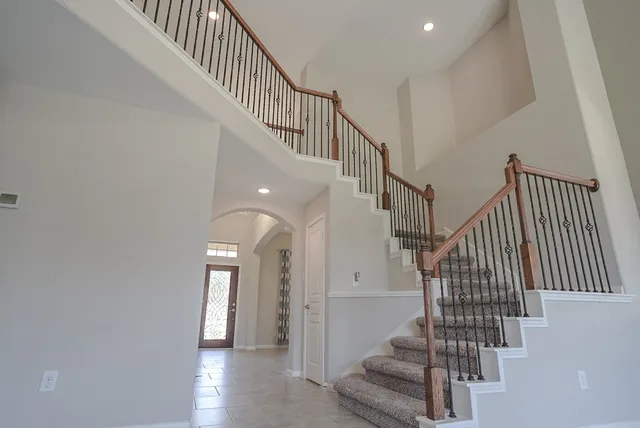 a view of an empty room with a fireplace and a window