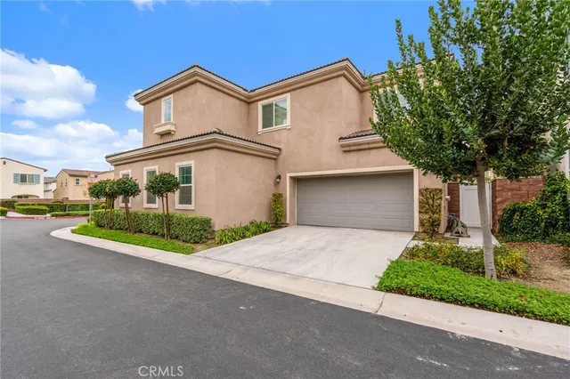 a view of a swimming pool with a lawn chairs under palm trees