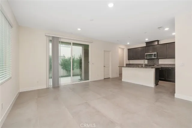 a view of a kitchen with a sink and dishwasher a refrigerator with wooden floor