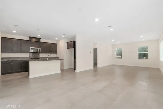 a view of kitchen with stainless steel appliances a refrigerator and a stove top oven