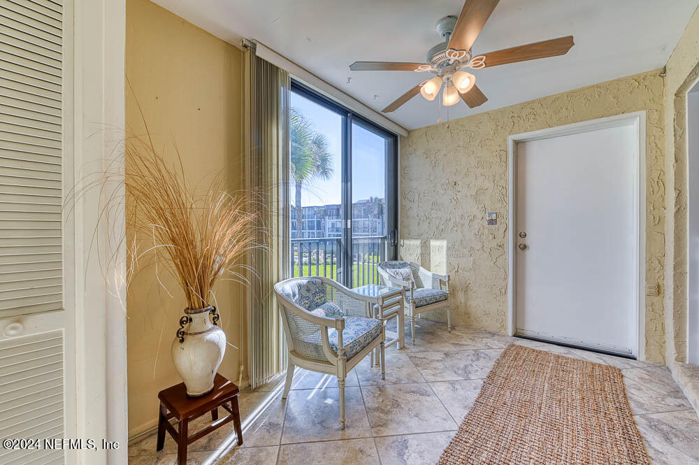 2321 Costa Verde Boulevard, Unit 201 Jacksonville Beach, FL 32250 - Photo 13 of 33 a living room with furniture and a window