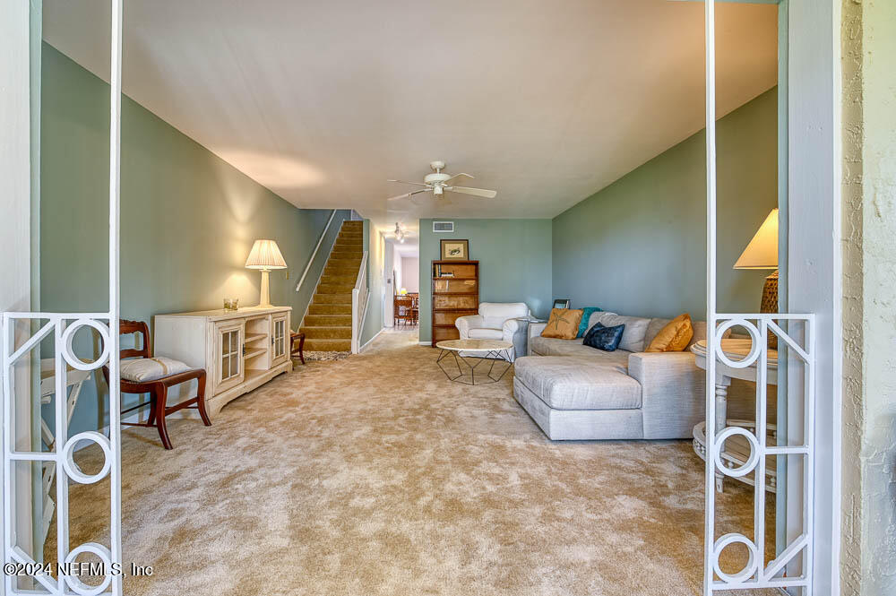 2321 Costa Verde Boulevard, Unit 201 Jacksonville Beach, FL 32250 - Photo 16 of 33 a living room with furniture and a wooden floor