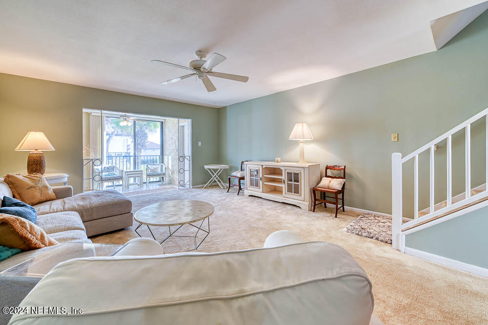 2321 Costa Verde Boulevard, Unit 201 Jacksonville Beach, FL 32250 - Photo 17 of 33 a living room with furniture and a large window
