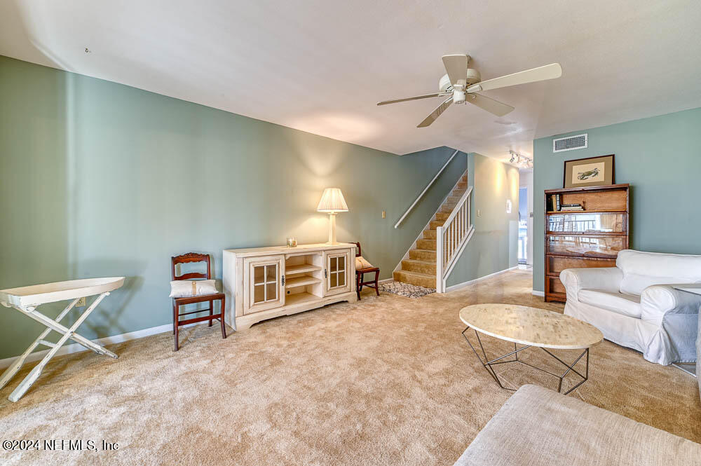 2321 Costa Verde Boulevard, Unit 201 Jacksonville Beach, FL 32250 - Photo 18 of 33 a living room with furniture and a wooden floor
