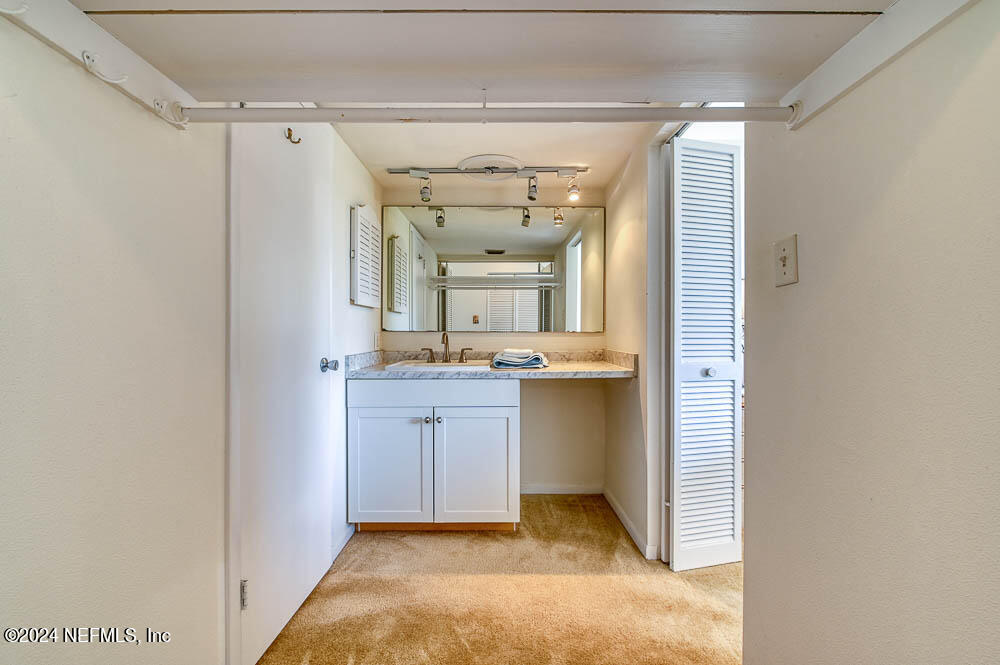 2321 Costa Verde Boulevard, Unit 201 Jacksonville Beach, FL 32250 - Photo 20 of 33 a bathroom with a sink and a mirror