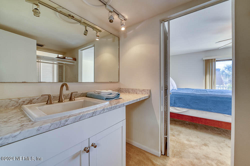2321 Costa Verde Boulevard, Unit 201 Jacksonville Beach, FL 32250 - Photo 23 of 33 a bathroom with a sink and a mirror
