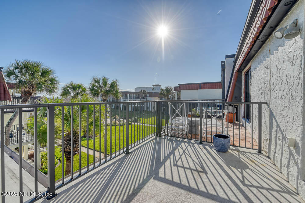2321 Costa Verde Boulevard, Unit 201 Jacksonville Beach, FL 32250 - Photo 26 of 33 a view of balcony with wooden floor and fence