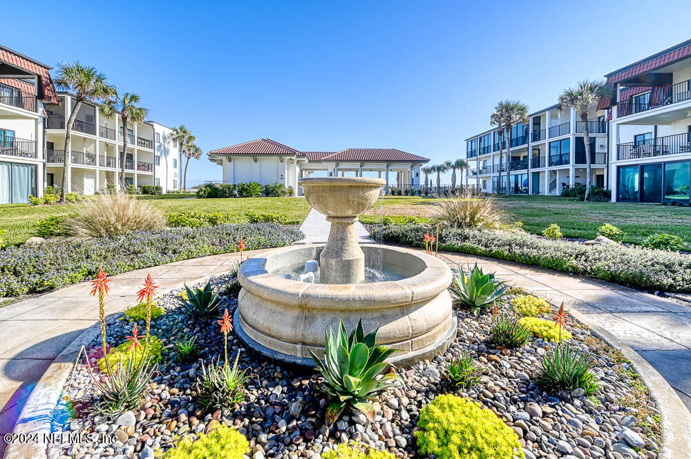 2321 Costa Verde Boulevard, Unit 201 Jacksonville Beach, FL 32250 - Photo 28 of 33 a view of a swimming pool with a garden