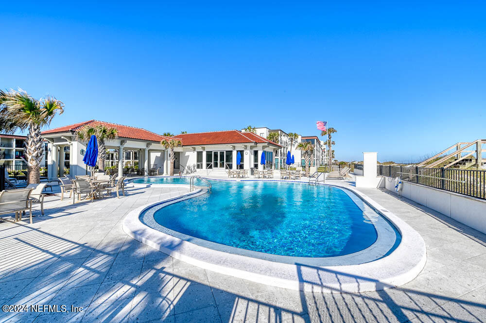 2321 Costa Verde Boulevard, Unit 201 Jacksonville Beach, FL 32250 - Photo 31 of 33 a swimming pool with outdoor seating and yard