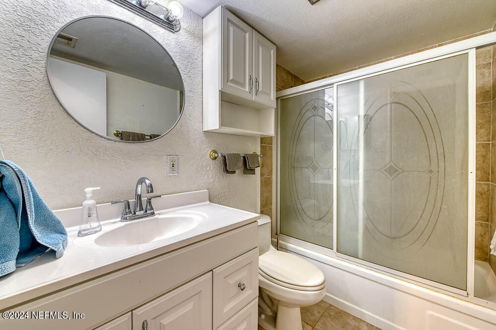 2321 Costa Verde Boulevard, Unit 201 Jacksonville Beach, FL 32250 - Photo 6 of 33 a bathroom with a sink a toilet and a mirror