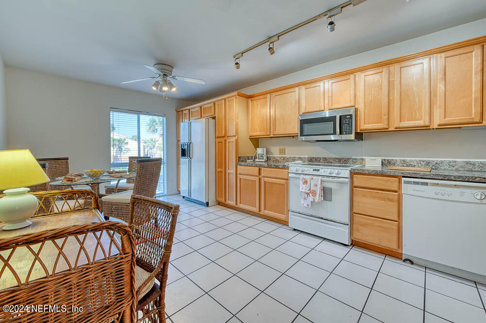 2321 Costa Verde Boulevard, Unit 201 Jacksonville Beach, FL 32250 - Photo 8 of 33 a kitchen with stainless steel appliances granite countertop a stove a sink dishwasher and a refrigerator