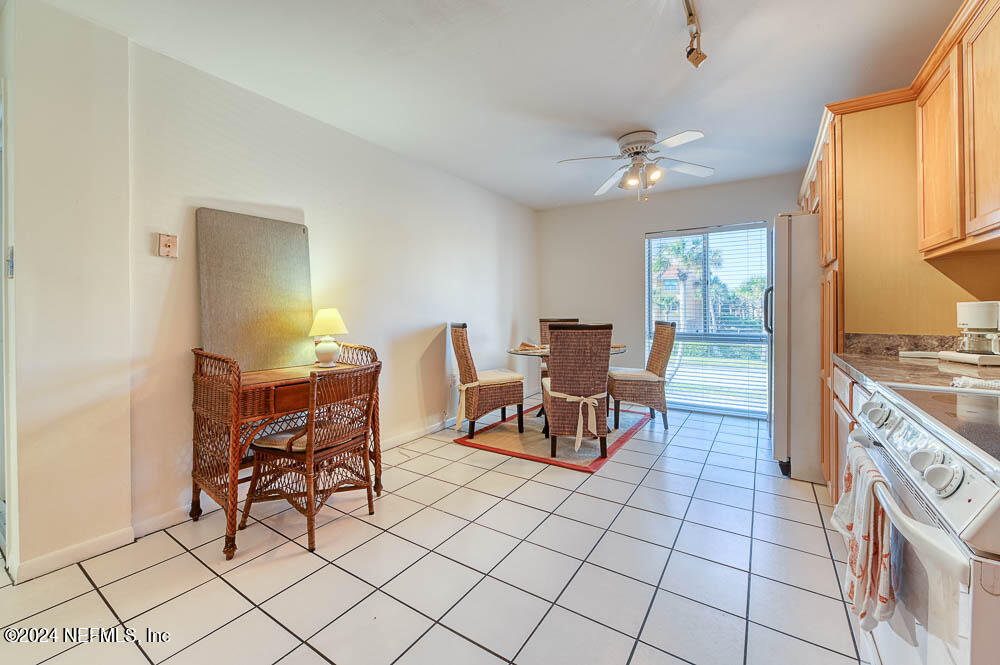 2321 Costa Verde Boulevard, Unit 201 Jacksonville Beach, FL 32250 - Photo 9 of 33 a view of a dining room with furniture and a chandelier fan