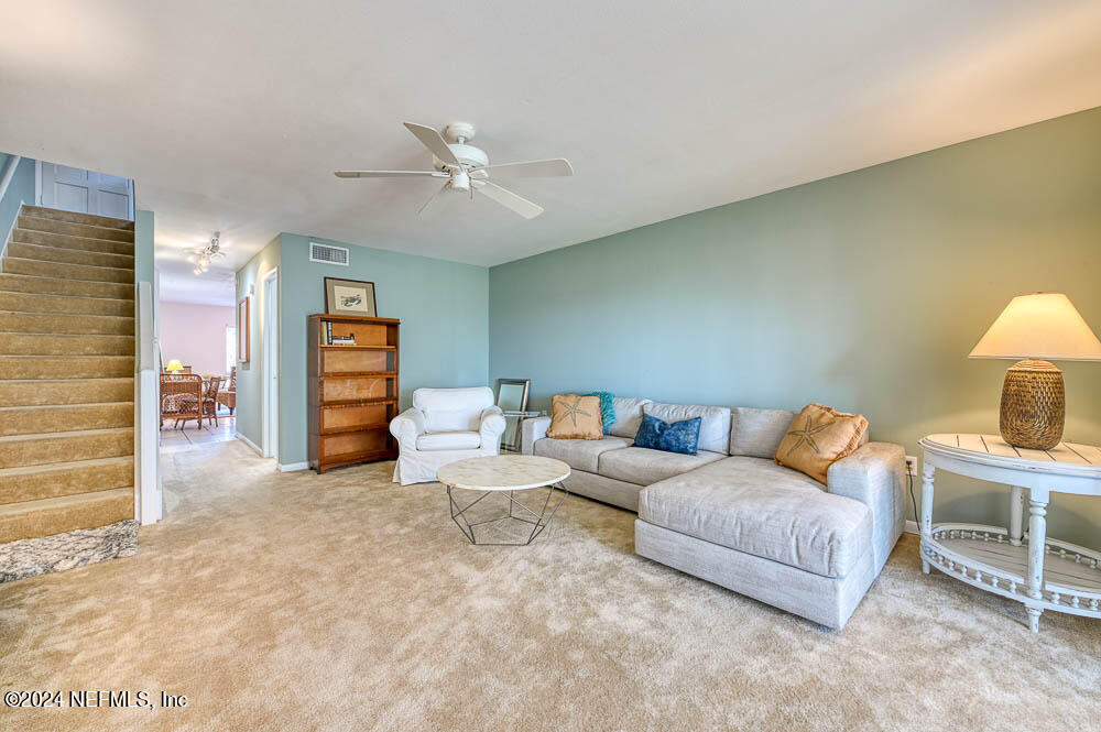 2321 Costa Verde Boulevard, Unit 201 Jacksonville Beach, FL 32250 - Photo 10 of 33 a living room with furniture and a lamp