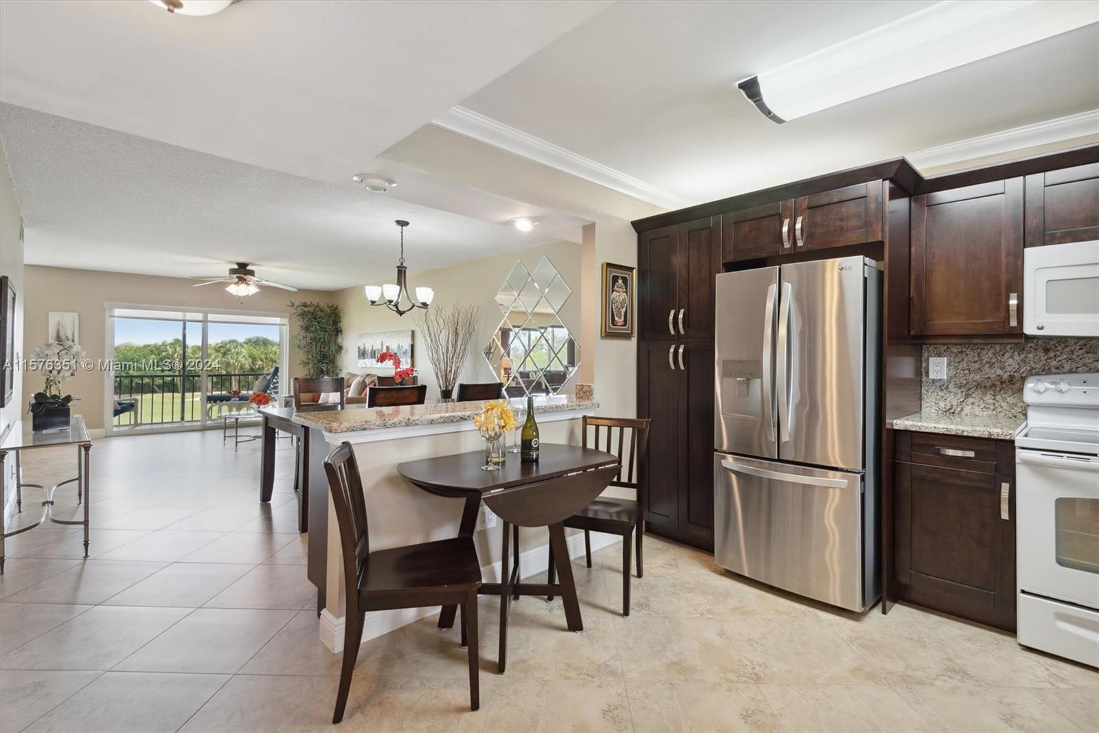 a kitchen with a refrigerator a dining table and chairs