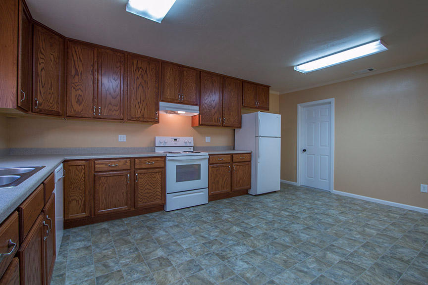 1732 Ash Street Fortuna, CA 95540 - Photo 10 of 37 a kitchen with stainless steel appliances granite countertop wooden cabinets a stove a sink and a refrigerator