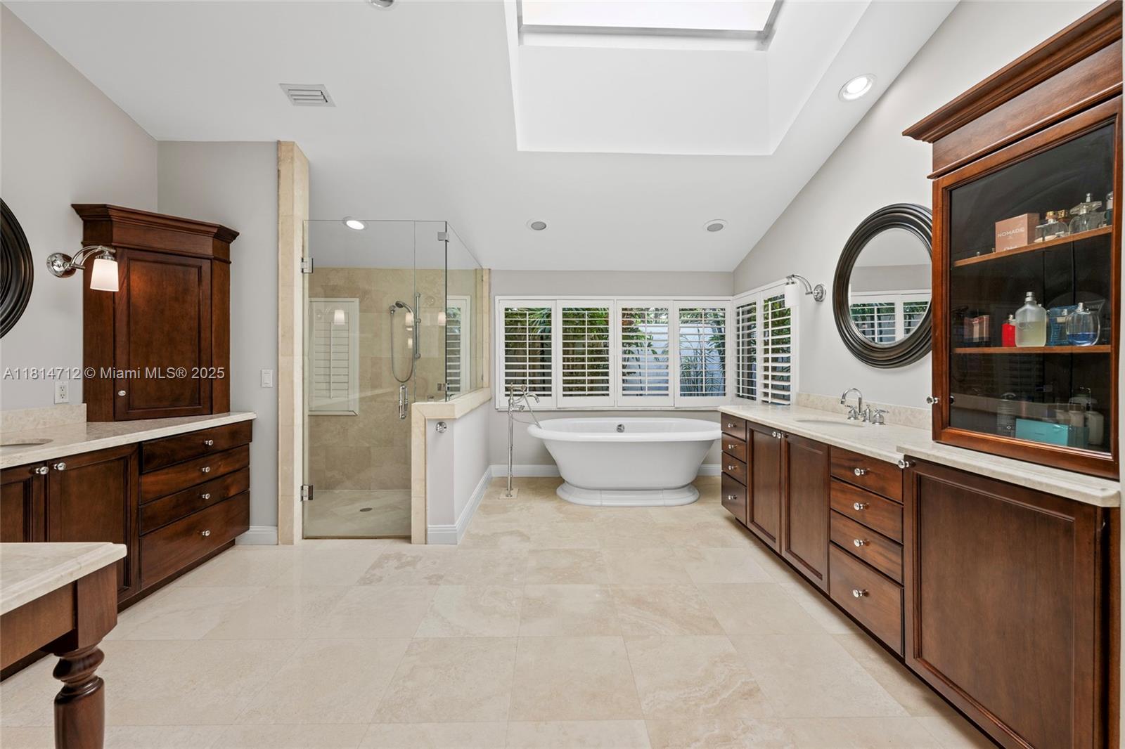 2805 Hackney Road Weston, FL 33331 - Photo 18 of 39 a spacious bathroom with a double vanity sink a large mirror and a bathtub