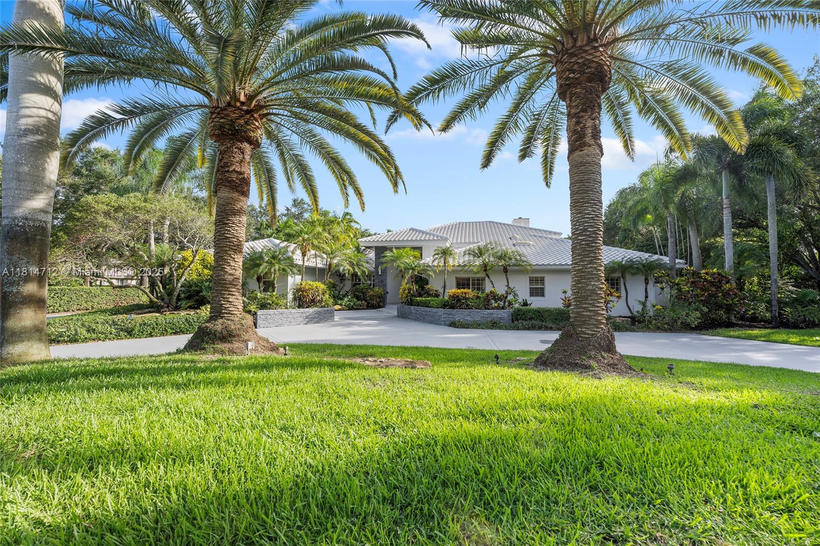 2805 Hackney Road Weston, FL 33331 - Photo 22 of 39 a view of a swimming pool with palm trees