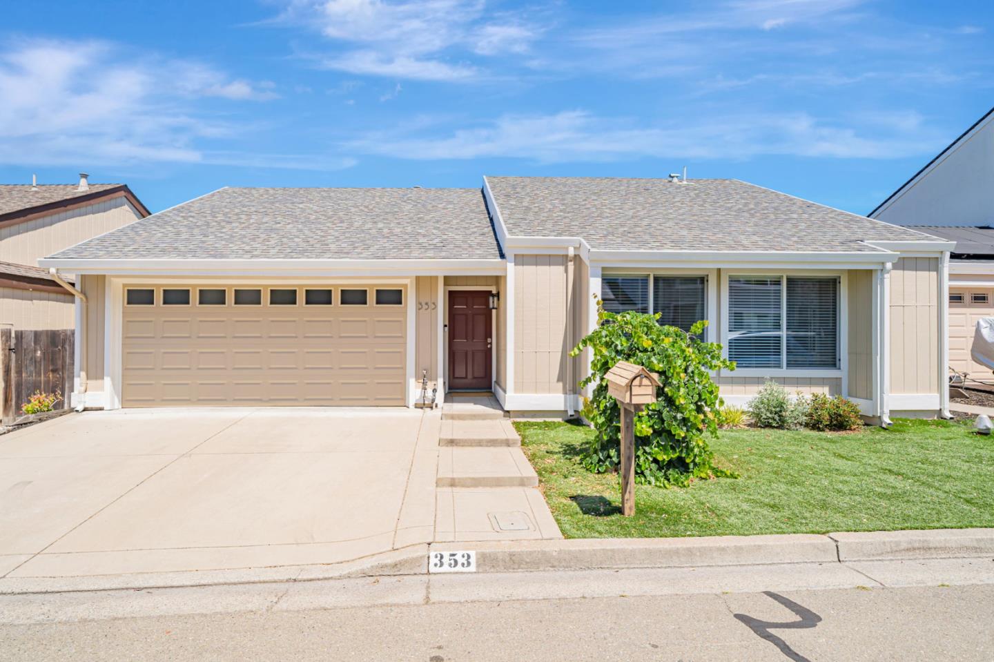 a front view of a house with a garden