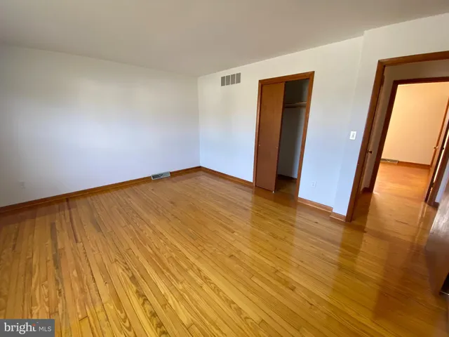 a front view of house with yard and trees around