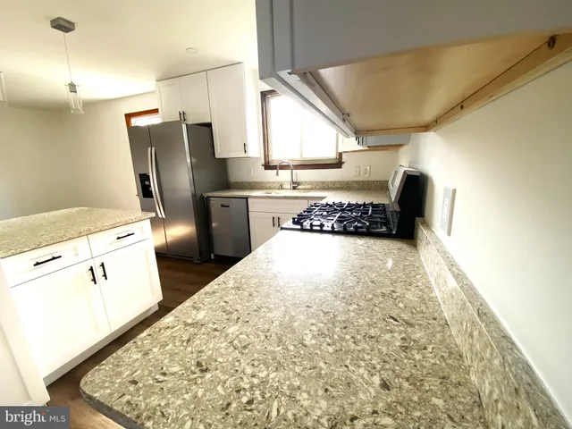 a kitchen with refrigerator and window