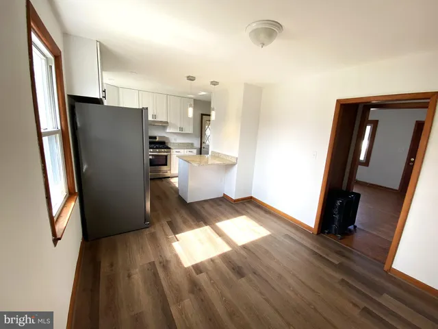 a kitchen with granite countertop white cabinets and stainless steel appliances