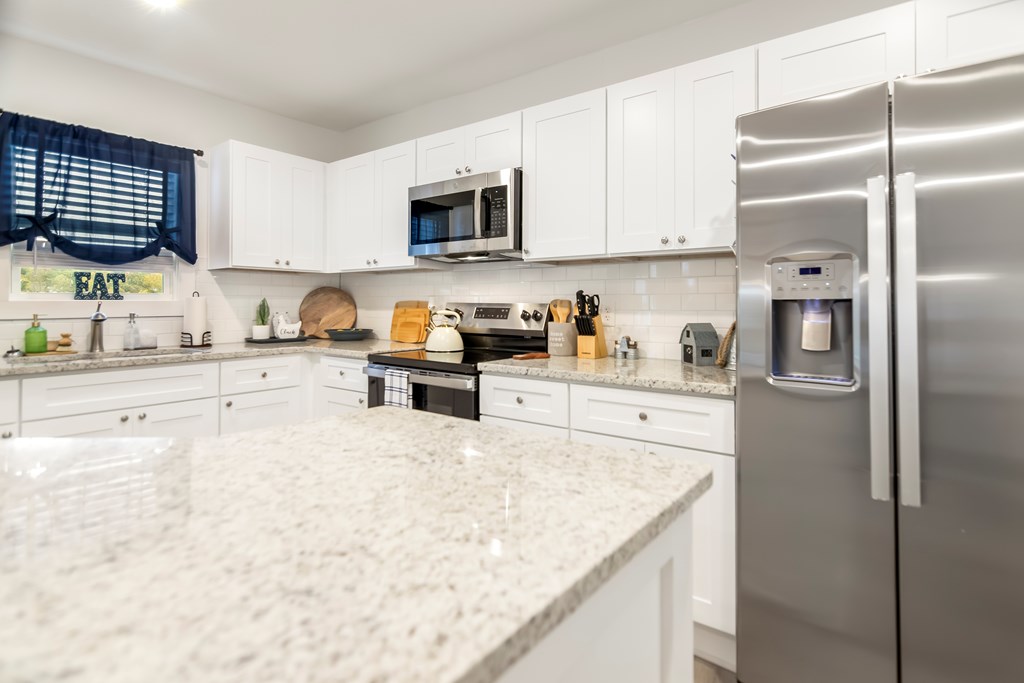 587 Oak Trace East Jasper, GA 30143 - Photo 21 of 47 a kitchen with stainless steel appliances granite countertop a refrigerator a sink a stove a microwave and cabinets