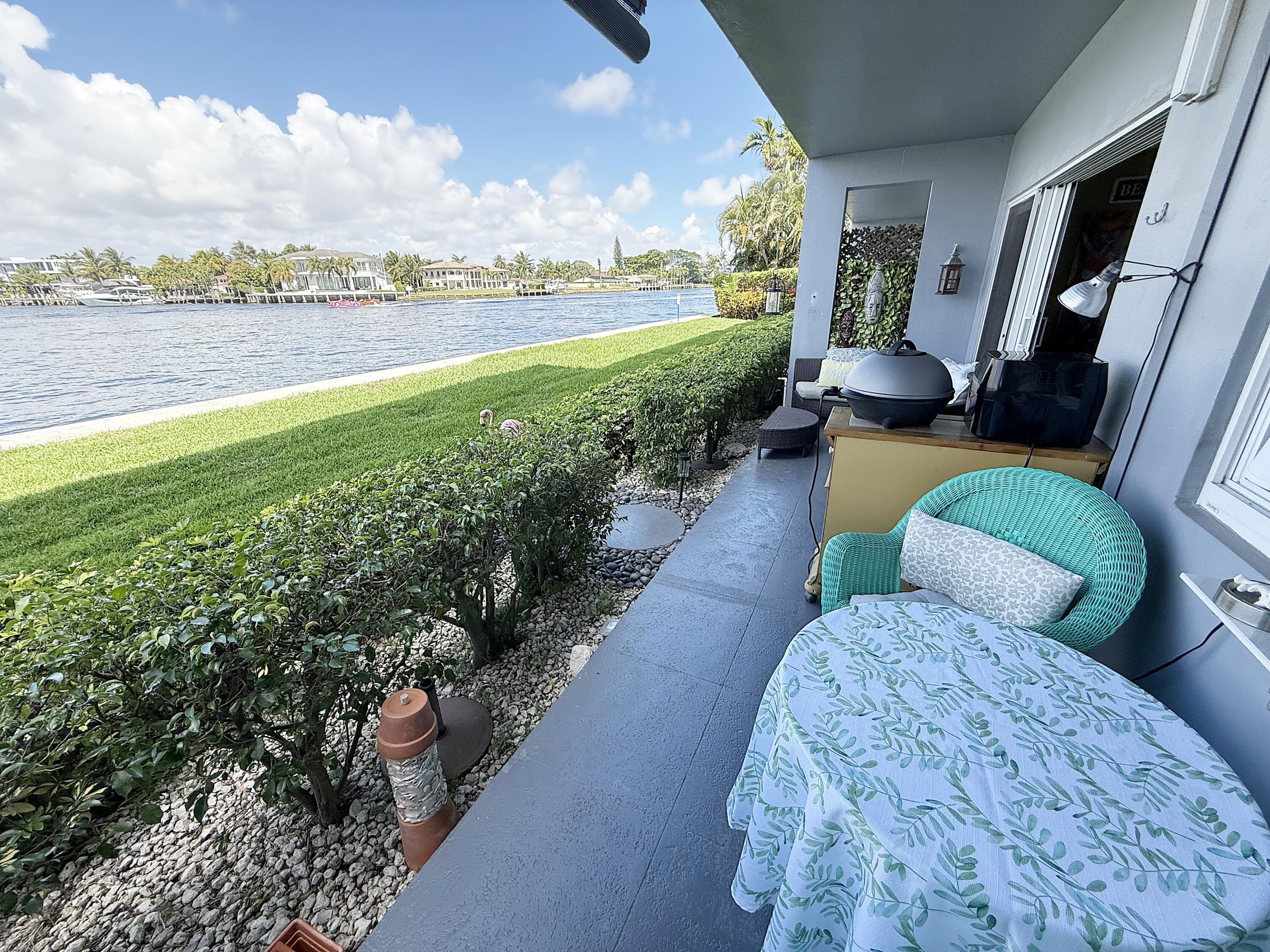 1201 South Riverside Drive, Unit 106 Pompano Beach, FL 33062 - Photo 12 of 28 a view of a porch with furniture and a yard