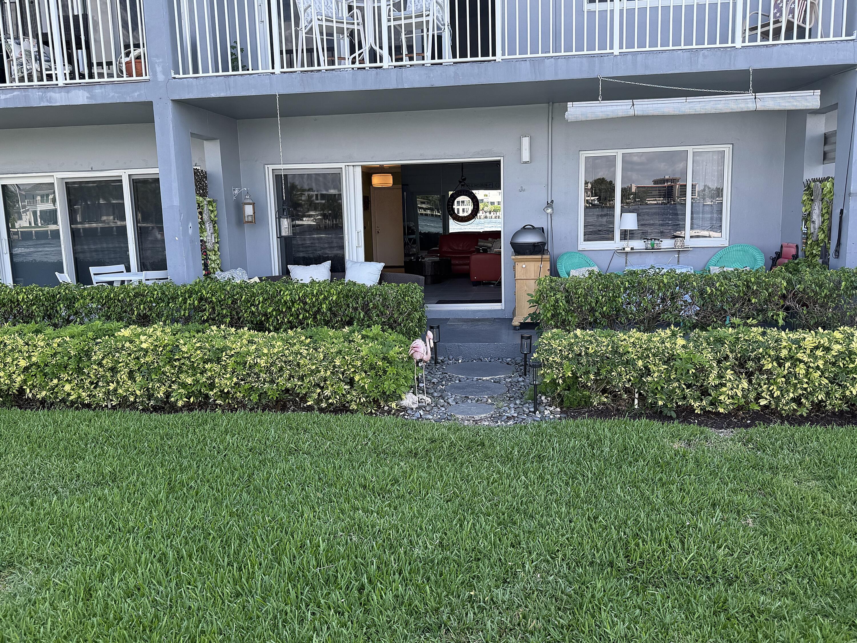 1201 South Riverside Drive, Unit 106 Pompano Beach, FL 33062 - Photo 13 of 28 a front view of a house with a yard