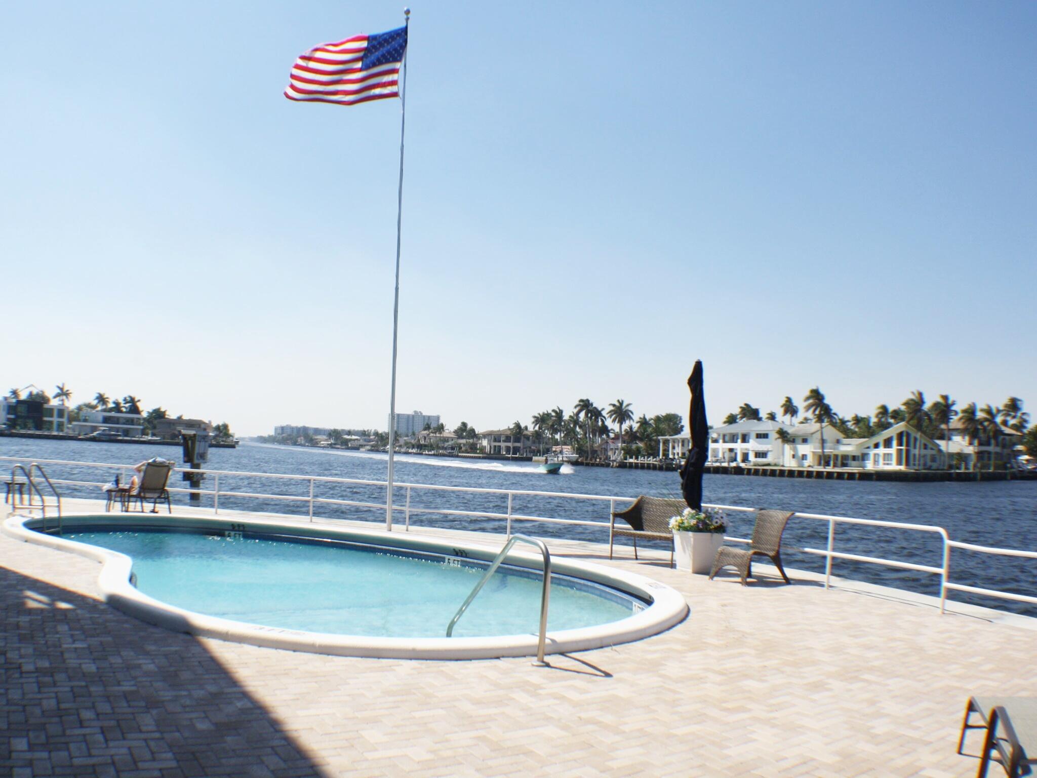 1201 South Riverside Drive, Unit 106 Pompano Beach, FL 33062 - Photo 20 of 28 a view of a swimming pool with a terrace