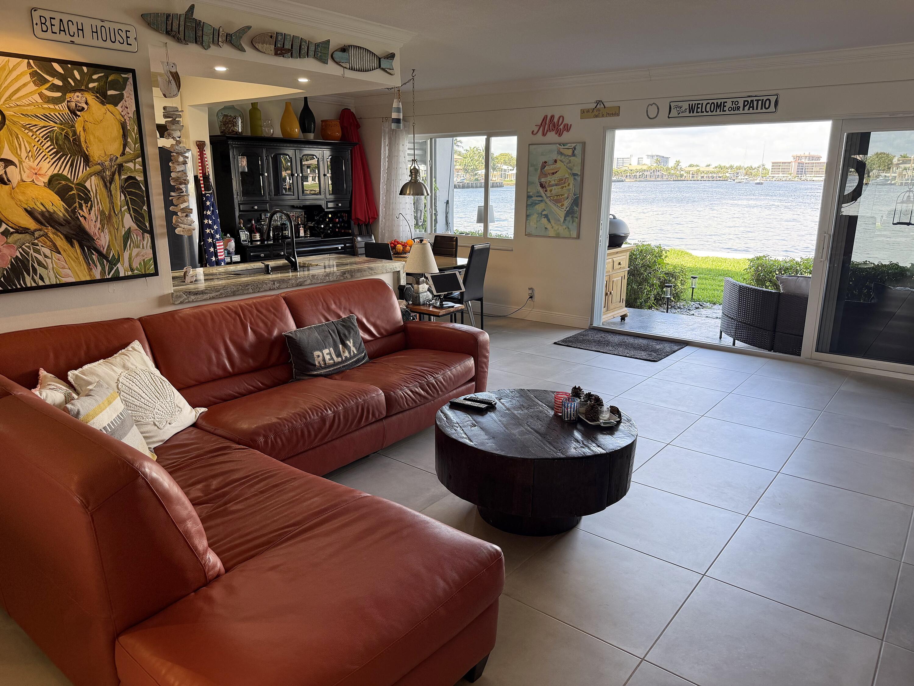 1201 South Riverside Drive, Unit 106 Pompano Beach, FL 33062 - Photo 2 of 28 a living room with furniture and a large window