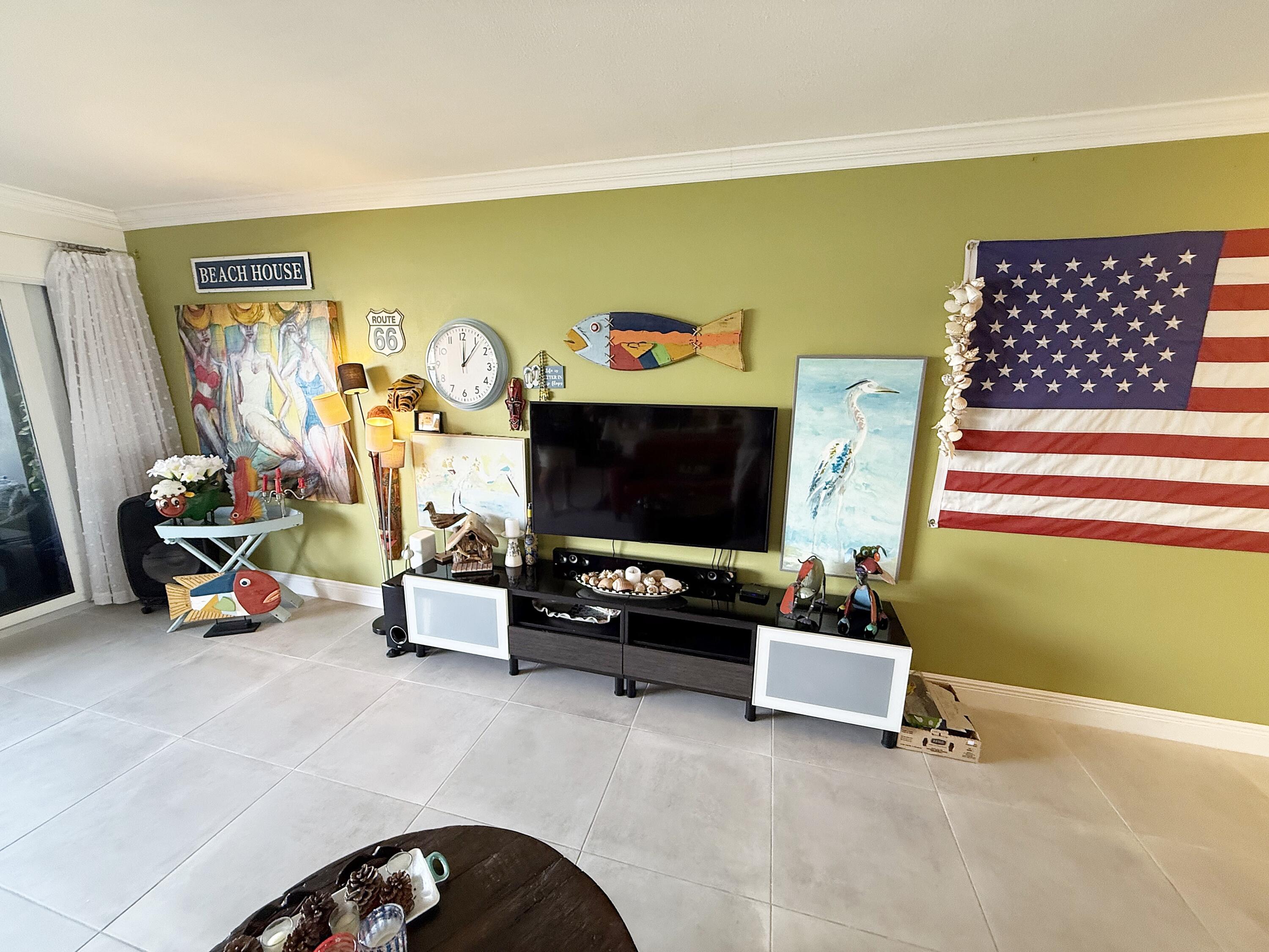 1201 South Riverside Drive, Unit 106 Pompano Beach, FL 33062 - Photo 4 of 28 a living room with furniture and a flat screen tv