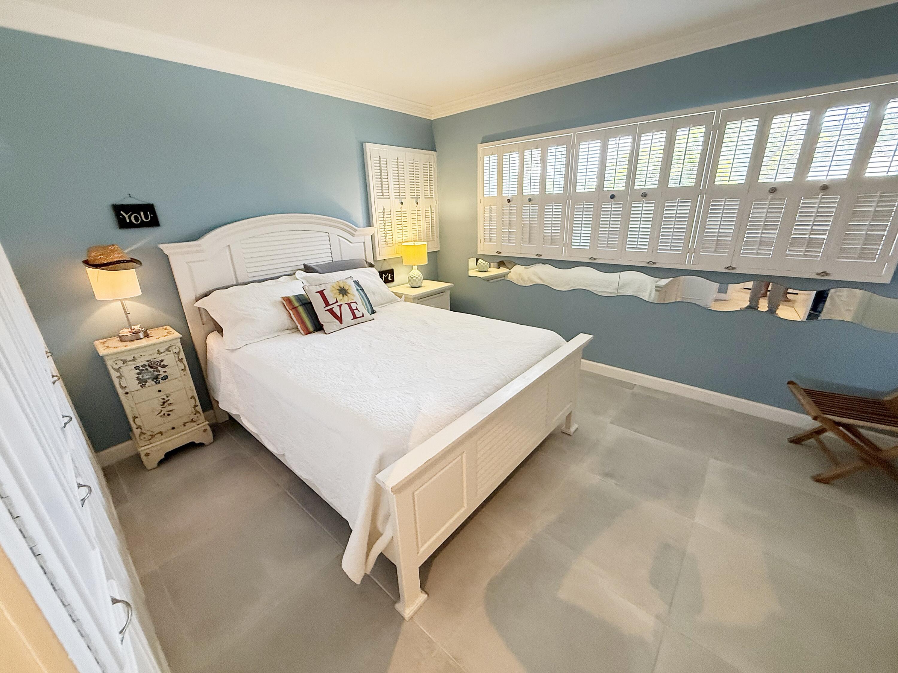 1201 South Riverside Drive, Unit 106 Pompano Beach, FL 33062 - Photo 5 of 28 a bedroom with a bed and a large window