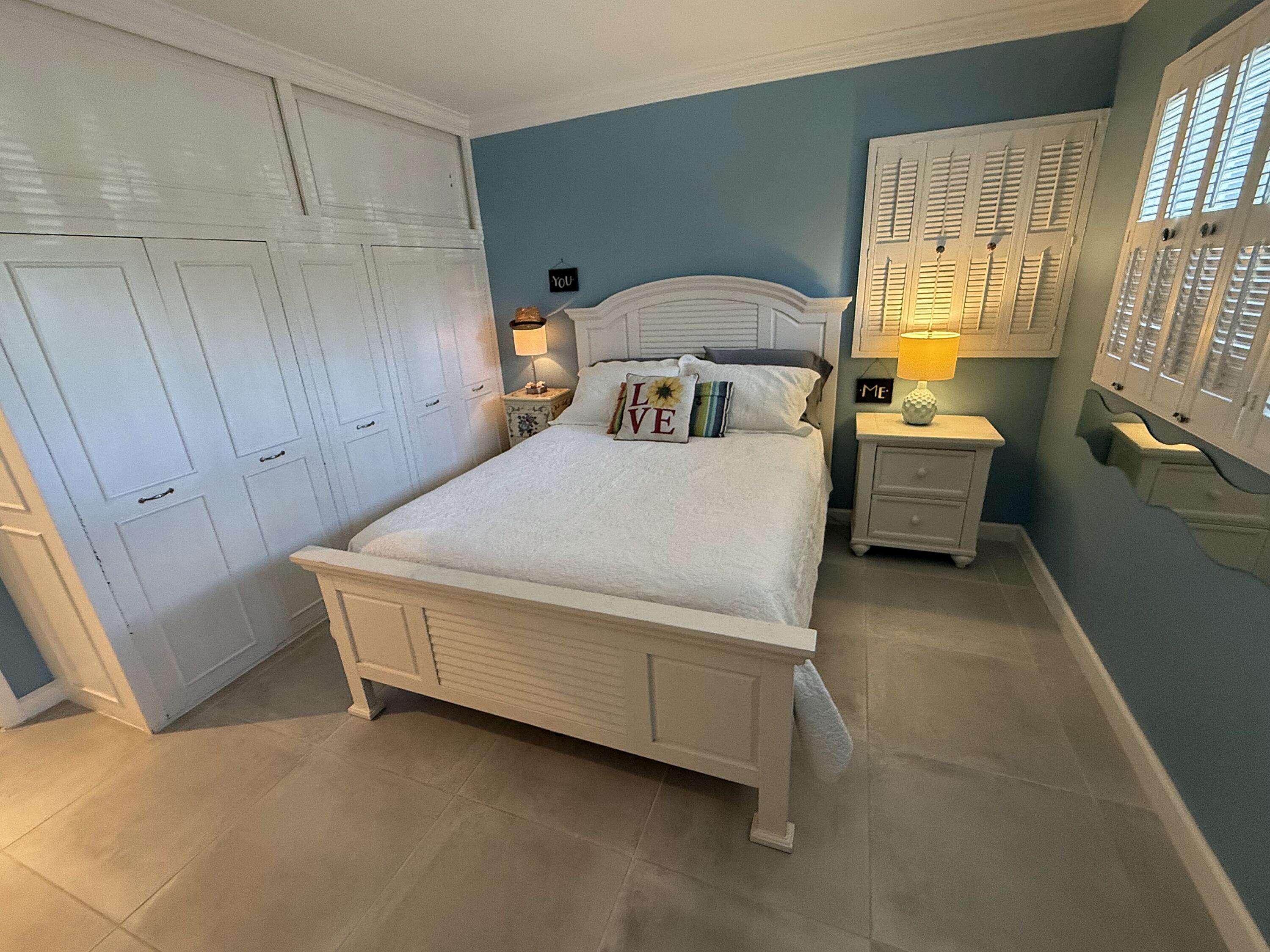 1201 South Riverside Drive, Unit 106 Pompano Beach, FL 33062 - Photo 7 of 28 a room with a bed and a dresser