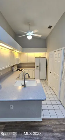 a view of a room with wooden floor and fan