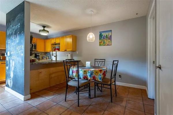a view of a dining room with furniture and a kitchen