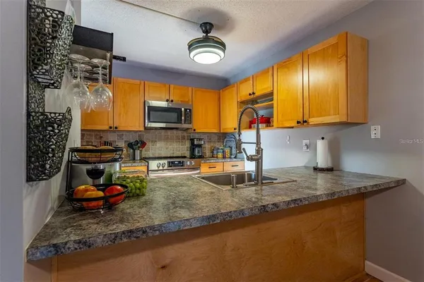 a kitchen with sink refrigerator and cabinets