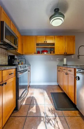 a kitchen with stainless steel appliances a stove and a microwave