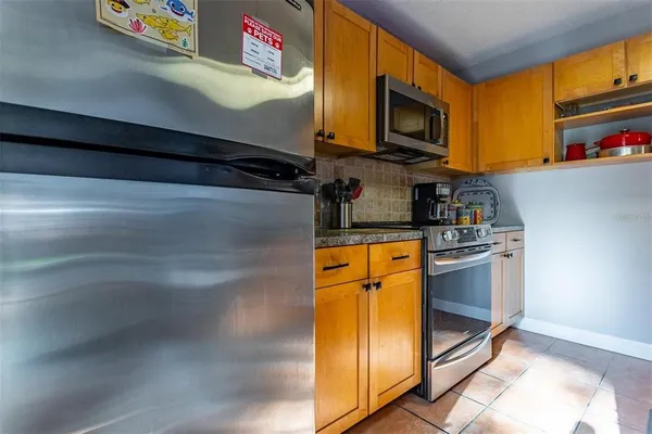 a kitchen with stainless steel appliances granite countertop a stove and cabinets