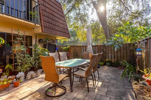 a view of a chair and table in backyard