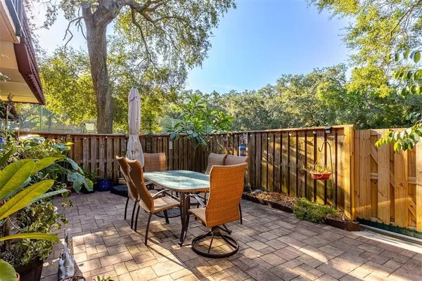a view of a patio with table and chairs and potted plants