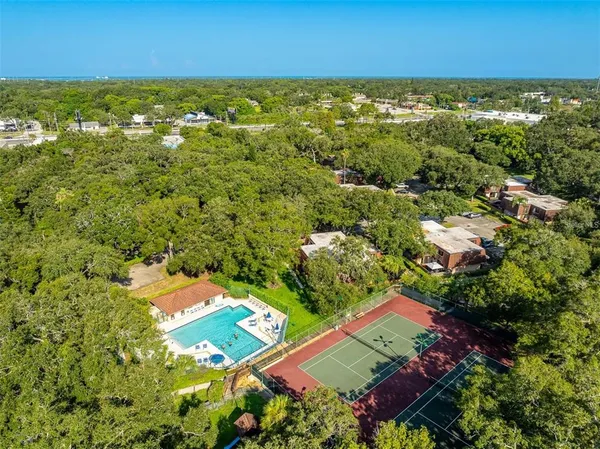 a aerial view of a house with pool and a yard
