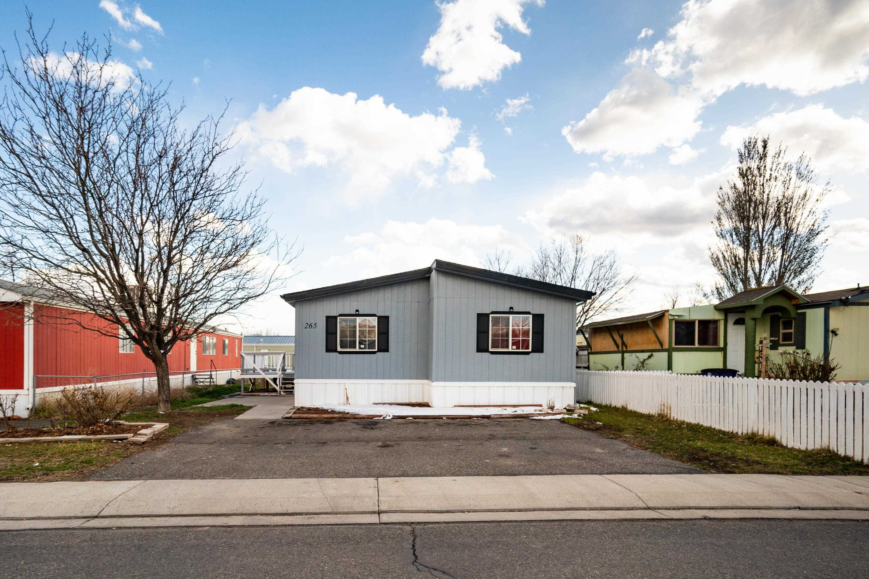 424 32 Road, Unit 265 Clifton, CO 81520 - Photo 2 of 21 a front view of a house with a yard and garage