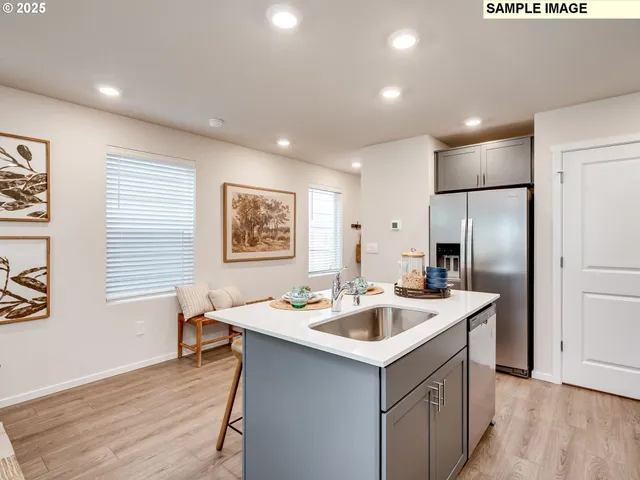 a kitchen that has a sink a table and chairs in it