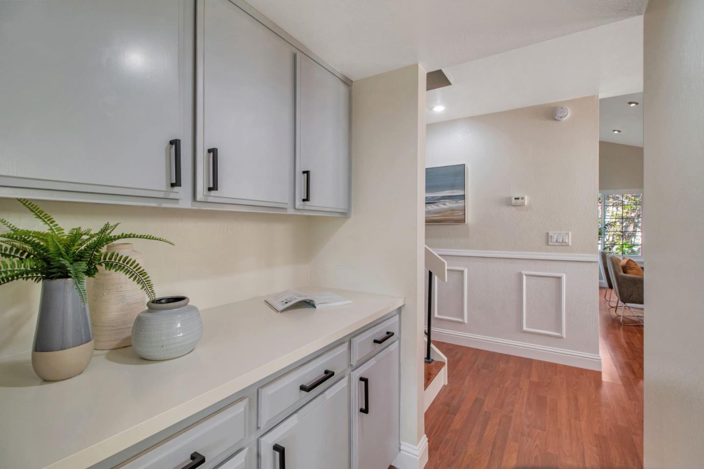 4793 Corte De Cervato San Jose, CA 95136 - Photo 14 of 45 a kitchen with a sink a potted plant and cabinets