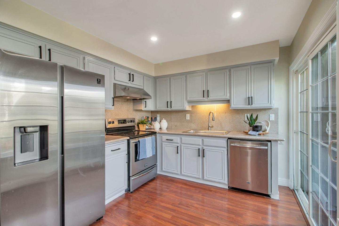 4793 Corte De Cervato San Jose, CA 95136 - Photo 23 of 45 a kitchen with granite countertop stainless steel appliances and wooden cabinets