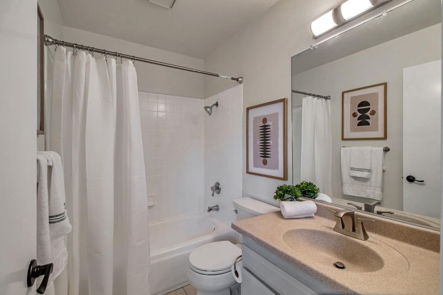4793 Corte De Cervato San Jose, CA 95136 - Photo 33 of 45 a bathroom with a granite countertop sink toilet a large mirror a shower and a bathtub