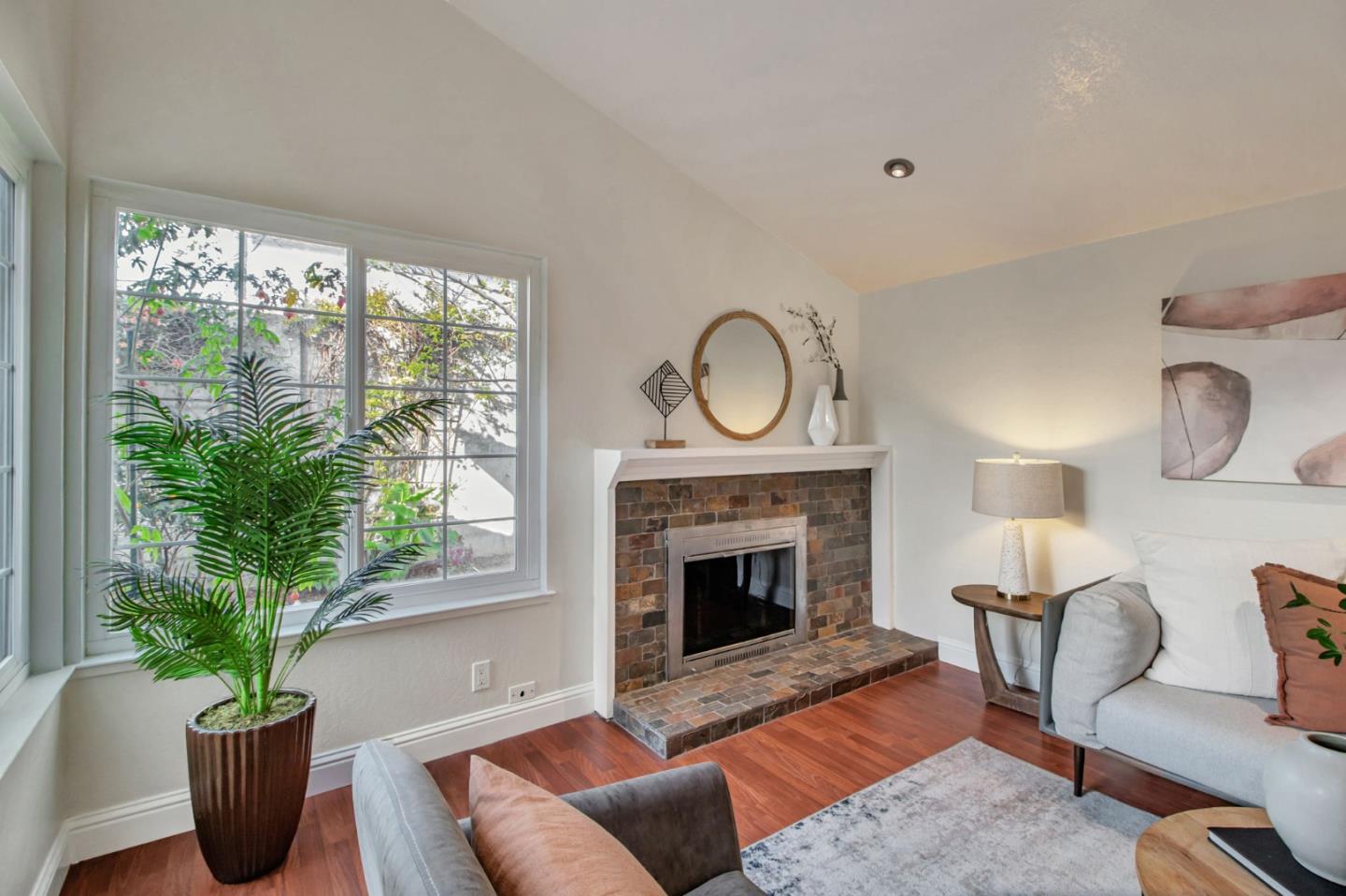 4793 Corte De Cervato San Jose, CA 95136 - Photo 9 of 45 a living room with furniture a potted plant and a fireplace