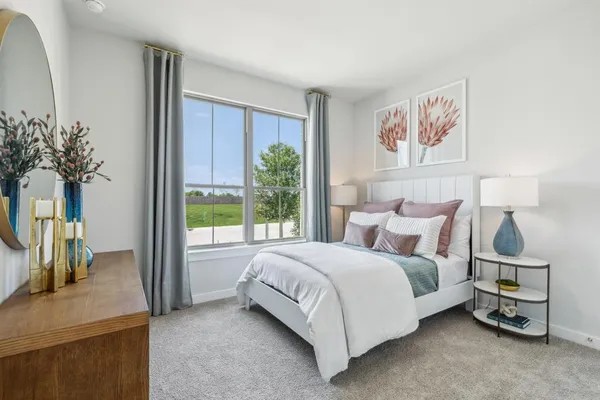a bedroom with a large bed and a window