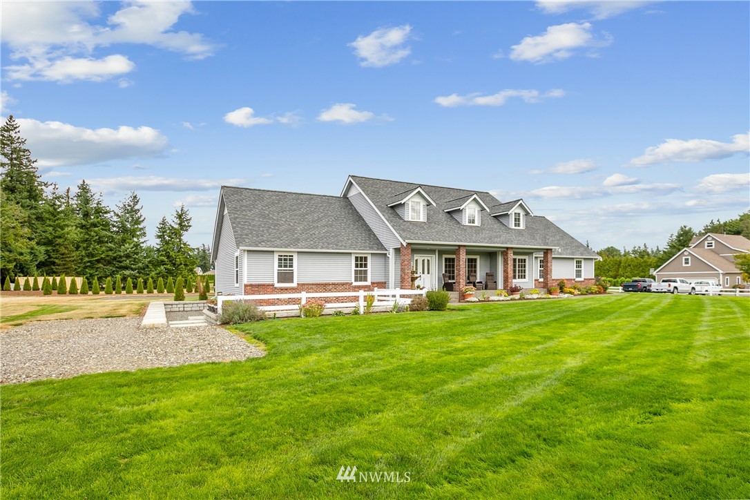 810 East Wiser Lake Road Lynden, WA 98264 - Photo 2 of 40 a front view of a house with a garden and plants
