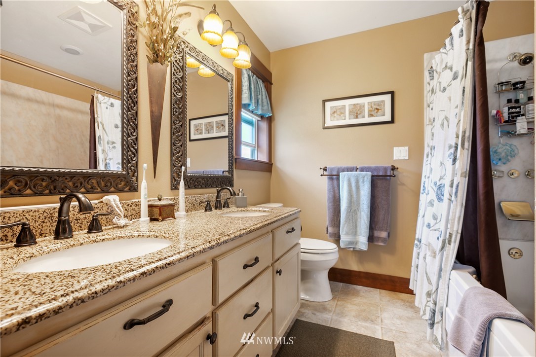 810 East Wiser Lake Road Lynden, WA 98264 - Photo 16 of 40 a bathroom with a granite countertop sink and a mirror